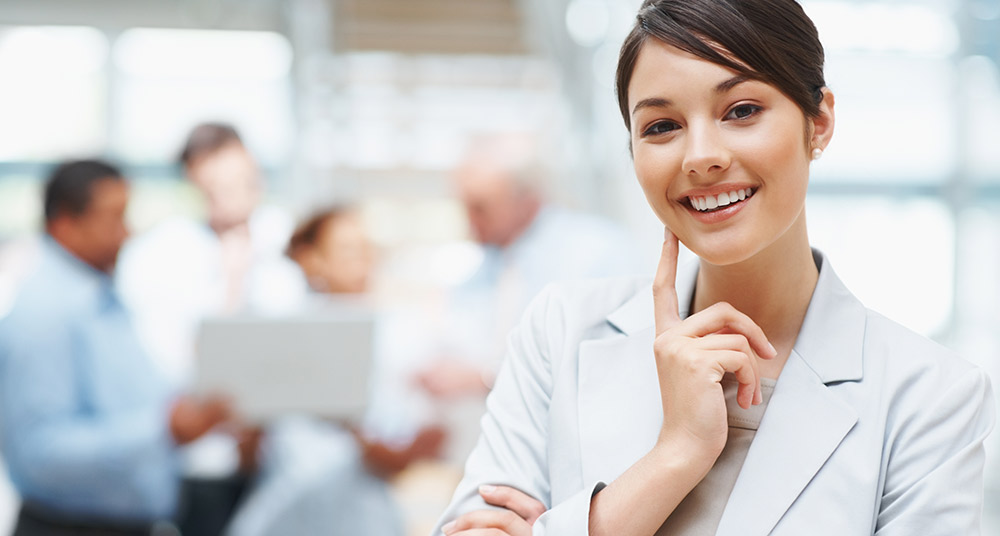 Home value postcard sample featuring a smiling businesswoman in a white blazer