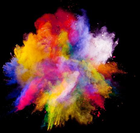 Explosion of colored powder bursting against a black background